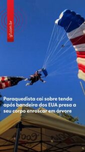 Paraquedista amarrado à bandeira gigante dos EUA se enrosca em árvore
