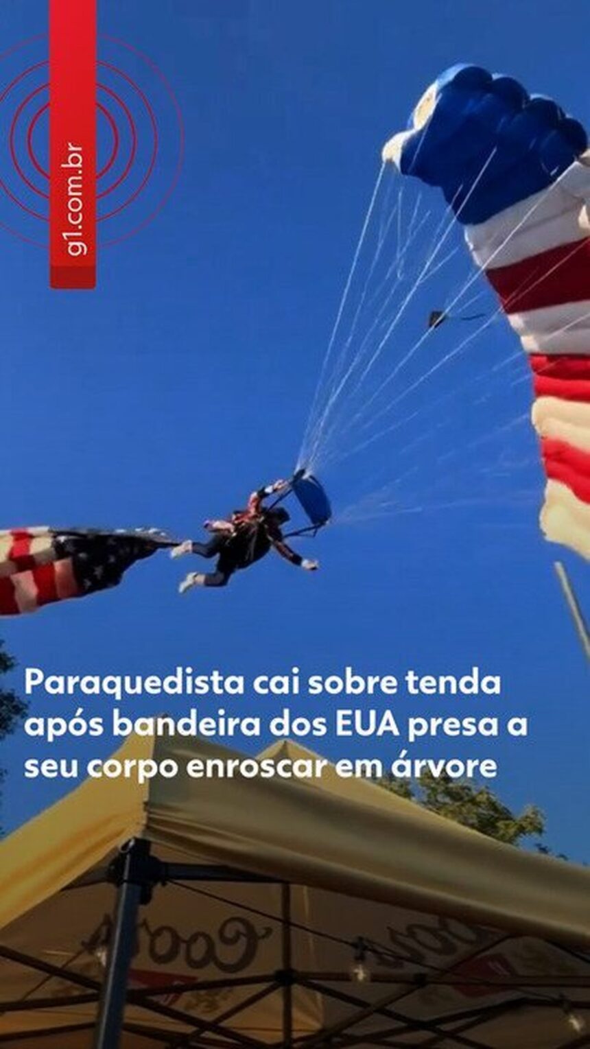 Paraquedista amarrado à bandeira gigante dos EUA se enrosca em árvore